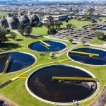 Aviso de drone aéreo de decantadores circulares usados em saneamento industrial mostrando o processo de tratamento de águas residuais de um ângulo de cima para baixo