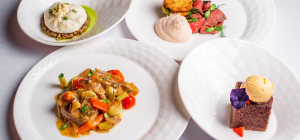 imagem apresenta a etapa final da jornada gastronômica: o prato servido com excelência técnica e estética em um ambiente de alta gastronomia.