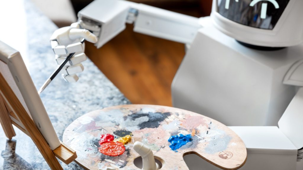 Robôs com inteligência artificial (IA) aprendem criatividade usando uma paleta de pintor, criando obras de arte. O conceito é de um robô autônomo que se tornará um artista.