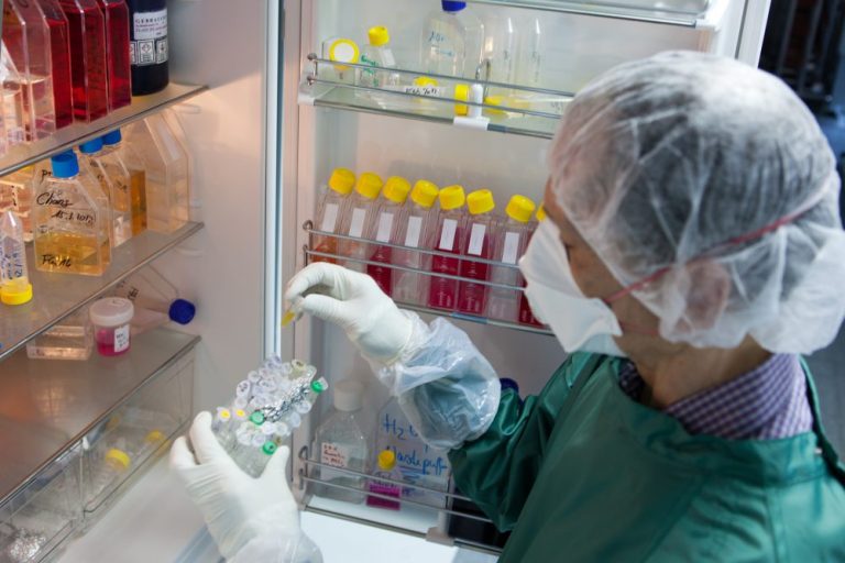 scientist takes a sample from the refrigerator