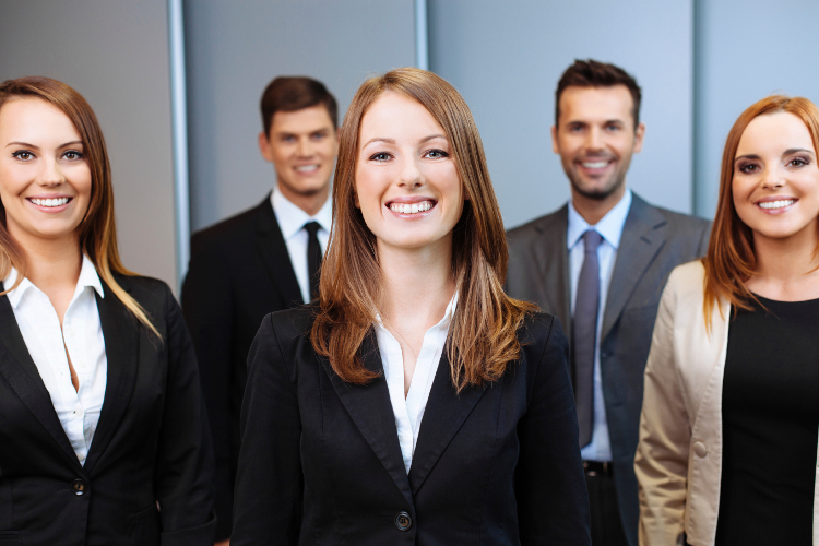 Group of happy business people with female manager in first row